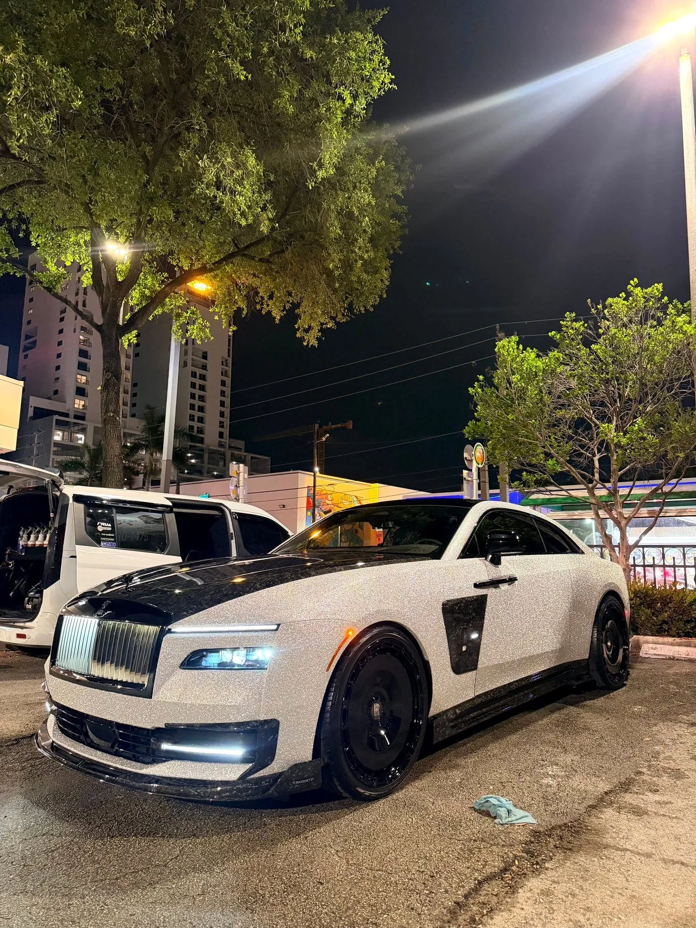 A crystal wrapped Rolls-Royce Spectre detailed by Highclass, shot at night in Miami